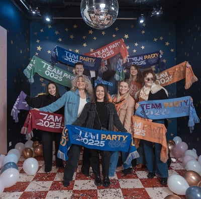 A photo of a team of people wearing square promotional polyester scarves in a variety of colors