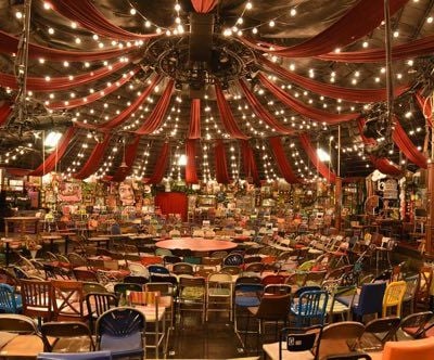 a circus tent with a circus tent and lots of chairs