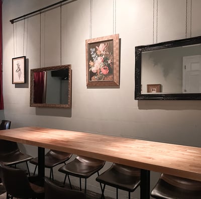 a table with chairs and mirrors on it