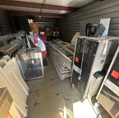 A storage unit filled with old junk appliances.