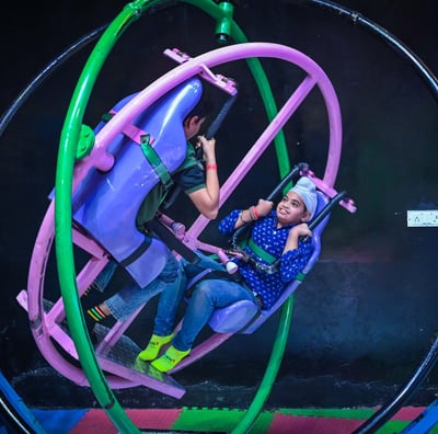 a woman riding a roller coaster at a carnival