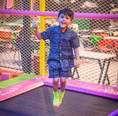 a young boy jumping on a trampoline trampoline trampoline tram
