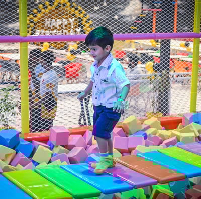 a young boy playing with blocks on a playground