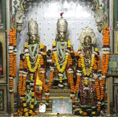 a group of three statues of hindu deities
