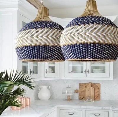 two large blue and white lamps hanging from a kitchen island