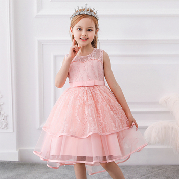 a little girl wearing a tiara and a beautiful peachy pink party dress