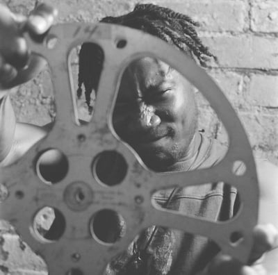 a man holding a film reel