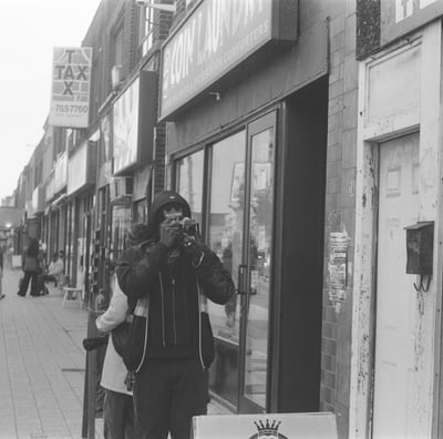 a man taking a picture of a woman on the phone
