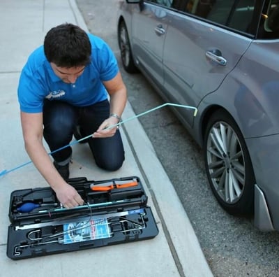 a man is fixing a toolbox in a car