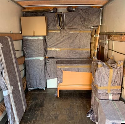 a moving truck with a bed and a bed in the back