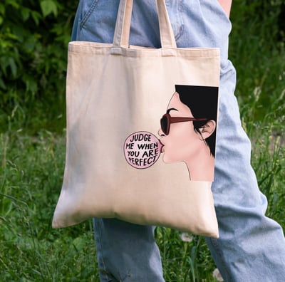 a person holding a bag with a picture of a woman's face