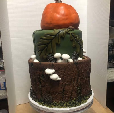 a cake with a pumpkin and a pumpkin on top of it