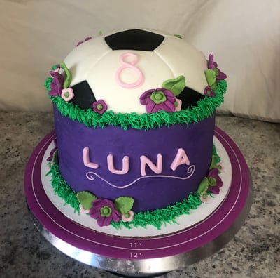 a cake with a soccer ball on top of a table