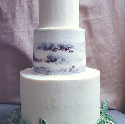 a cake with a white frosted cake topper