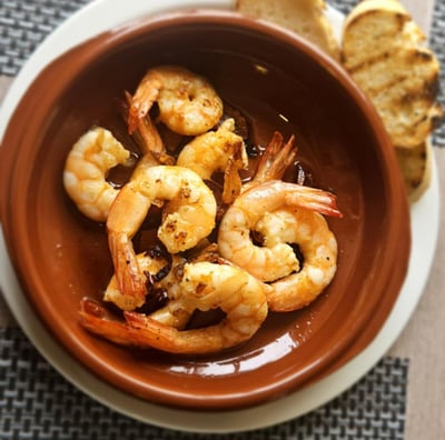 Crispy fried calamari served in a bowl as a delicious seafood starter, garnished with herbs