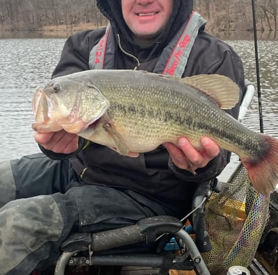 a man in a kayak holding a fish