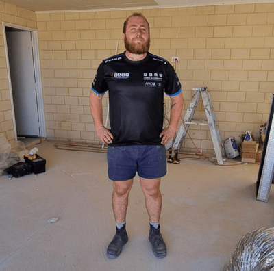 a man standing in a room with a ladder