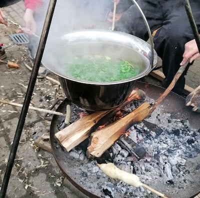 Gemüsesuppe auf dem Dreibein kochend
