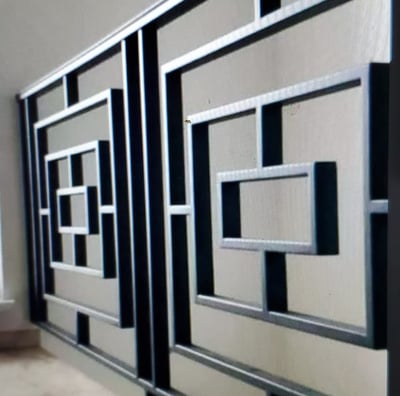 a wall mounted metal art deco paneled in a room