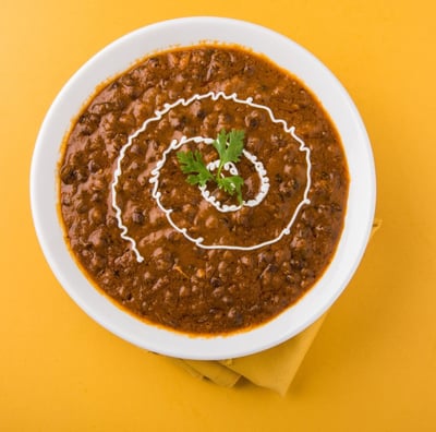 a bowl of dal makhani bukhari with cream