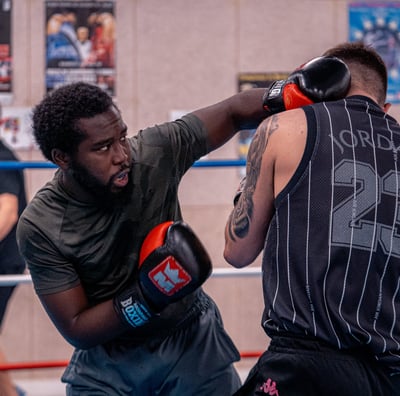 Boxeur qui envoie un coup de poing dans le visage de son adversaire