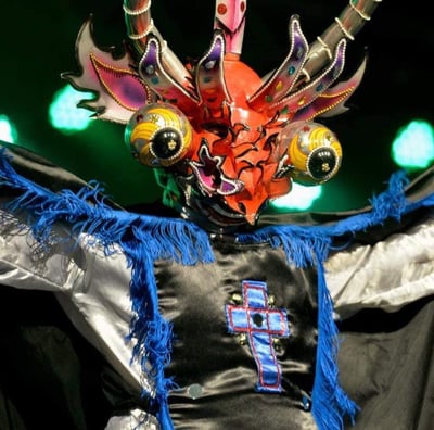 a man in a costume with a dragon headdress