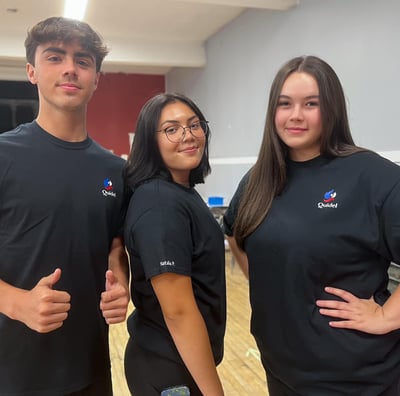 three people standing in a room