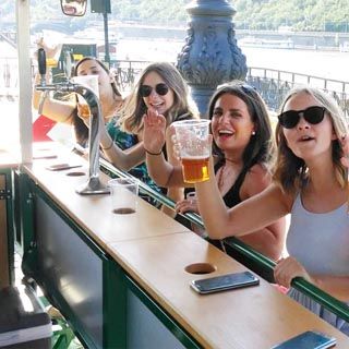 a group of women sitting at a Beer Bike Riga