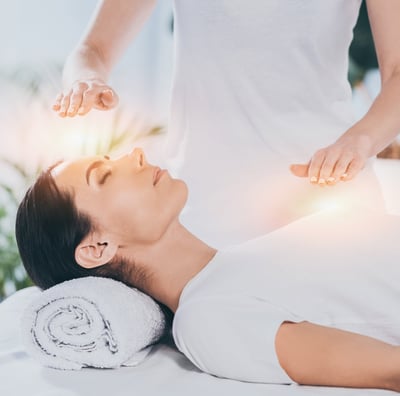 a woman is getting healed in a energy healing session