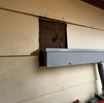 a house with a hole in its siding