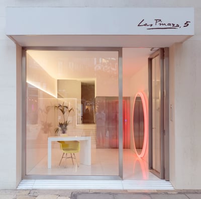 a storefront door with a neon red neon ring