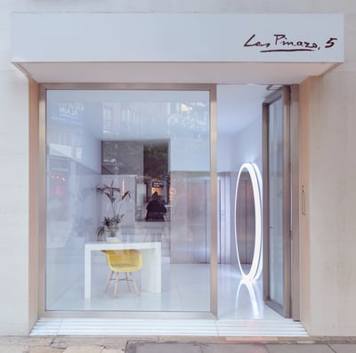 a storefront door with a yellow chair and a yellow chair