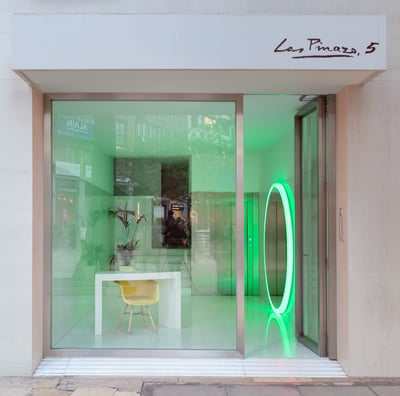 a storefront door with a neon green neon ring