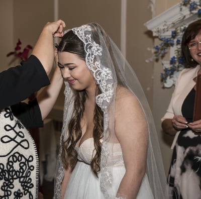 Hertfordshire Bride getting her veil pinned by the hairdresser, officiant smiling in the background.