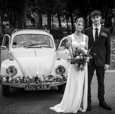 Black & White photo of a Bedfordshire bride and groom in front of the VW Beatle wedding car