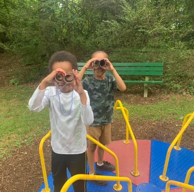 Children playing on the merry-go-round at Crescent Hills park