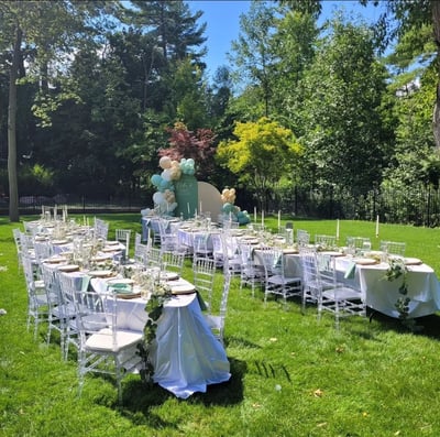 Table setting for 60 people with a balloon backdrop