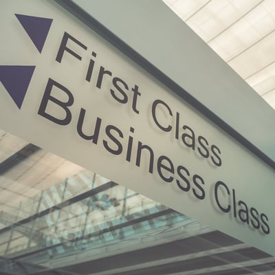 a sign that says first class business class in airport