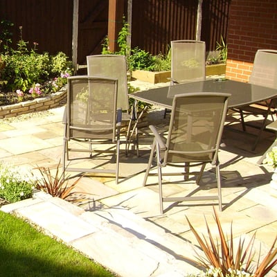 patio design enclosed by raised beds and lawn