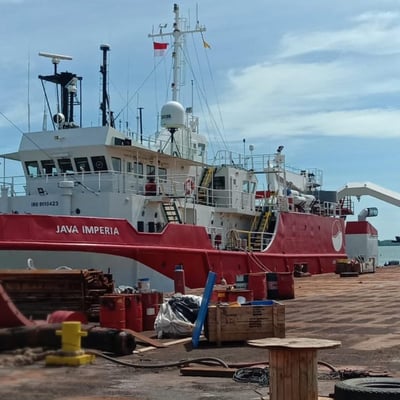 a red and white boat docked at a dock