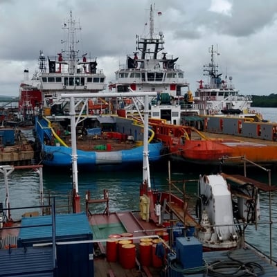 a large boat docked at a dock with a few boats