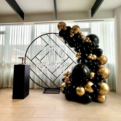 Black and gold balloon backdrop rental