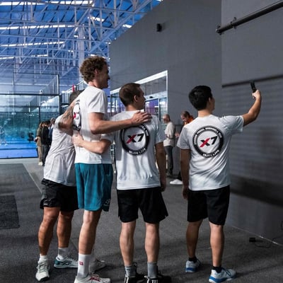 Padel training camp students taking a selfie with their coach at Padel X7 Sabadell in Spain after a 