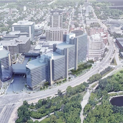 a large multi building office tower set in a city with a river running through it