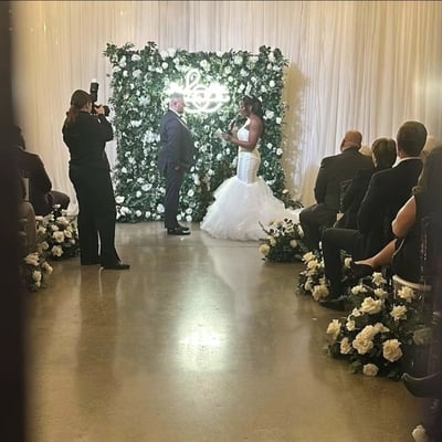 Wedding ceremony with our 8ft x 8ft rose garden flower wall at the Eglington West Gallery in Toronto