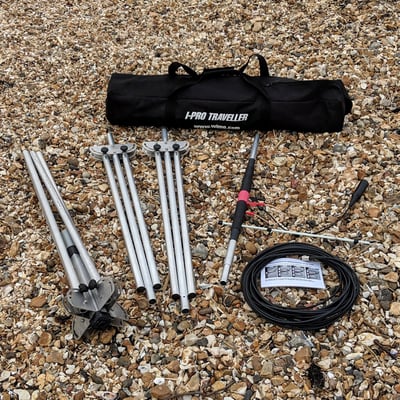 Pro Antennas I-Pro Traveller HF antenna components laid out on a pebble beach