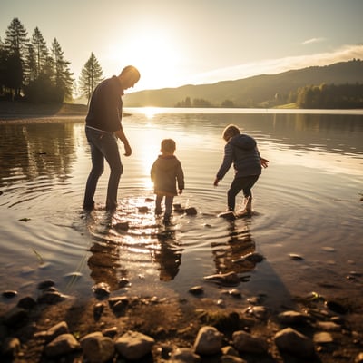 a-family-of-three-skipping-stones-at-the-calm-waters-of-lake-most-na-soci-in-slovenia