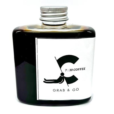a bottle of coffee with a black and white label