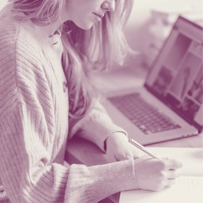 A woman working at her desk for Excellence