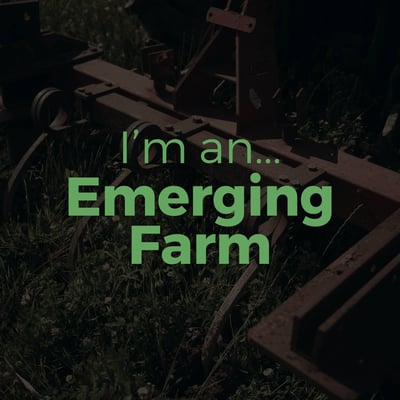 a tractor with a green sign that says i'm an emerging farmer